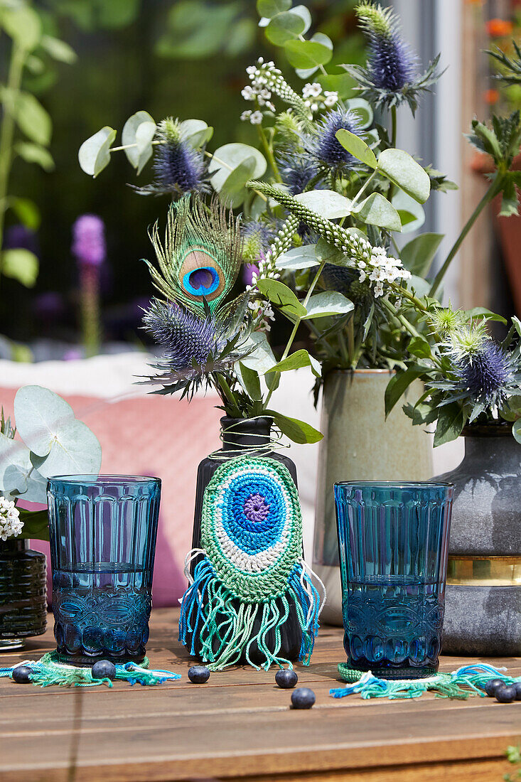 Vase with crocheted peacock feather