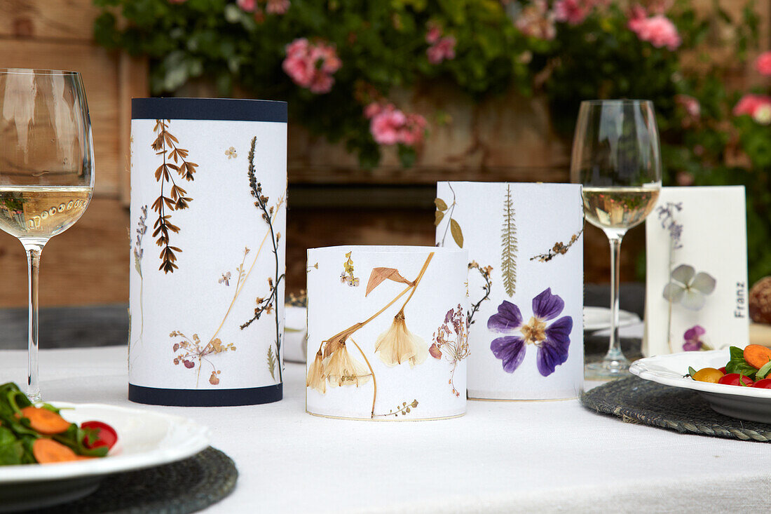 Table decoration made from lanterns with dried flowers at a garden party