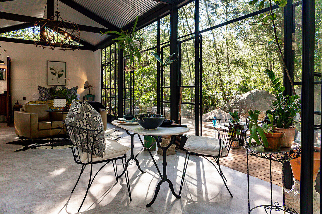 Open living room with dining area in the glass house