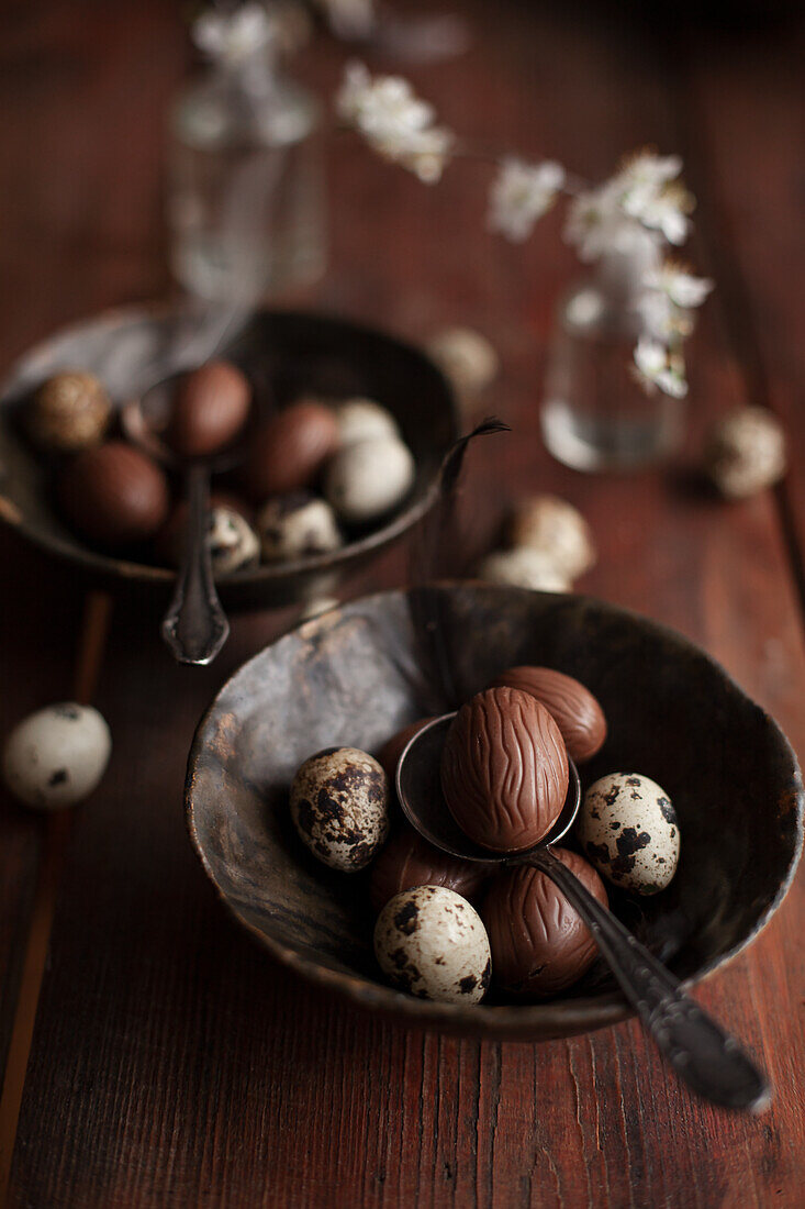 Chocolate eggs and quail eggs in vintage bowl