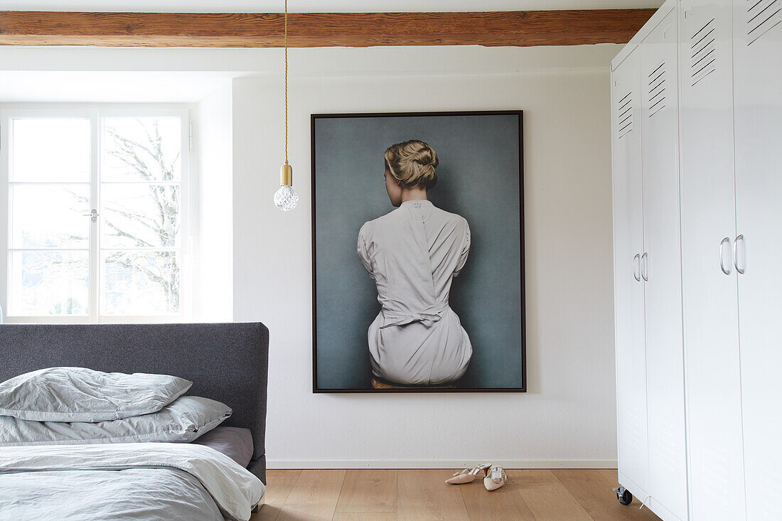 Large-format photo and white metal cupboards in the bedroom