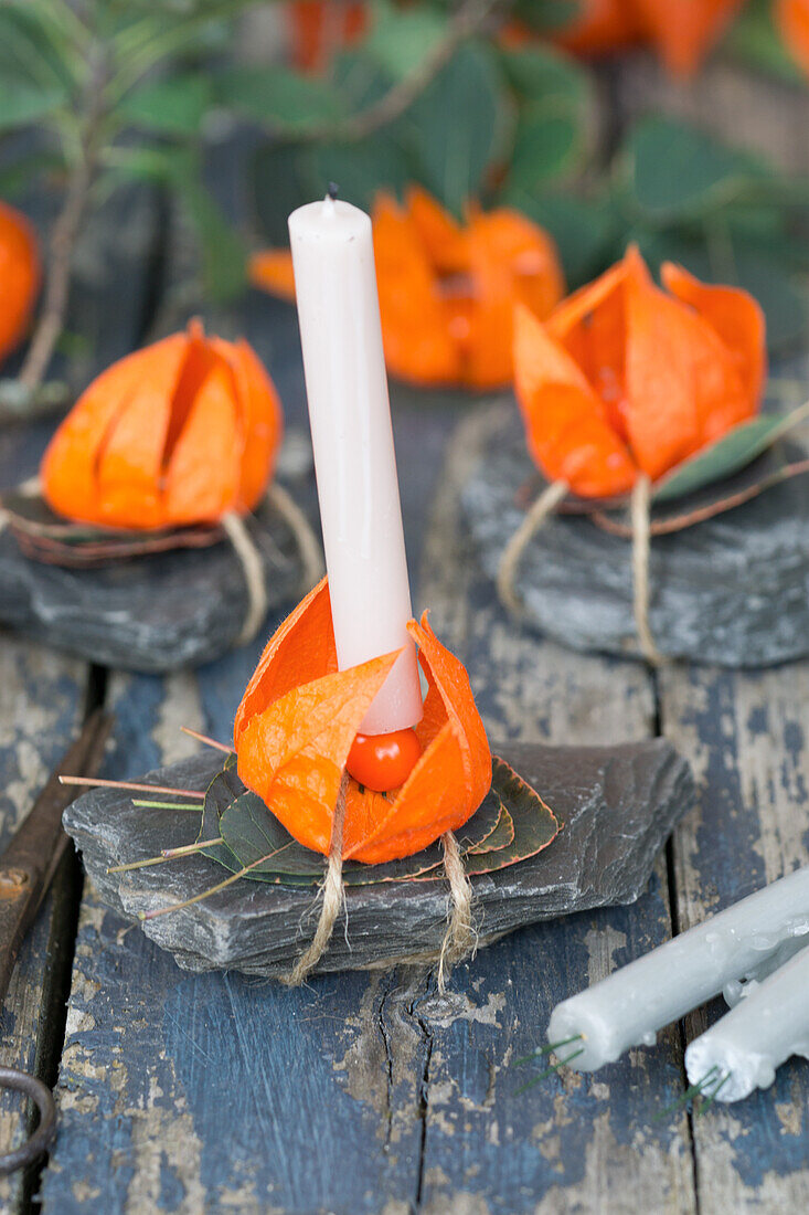 Candle in candle holder made of lantern flowers