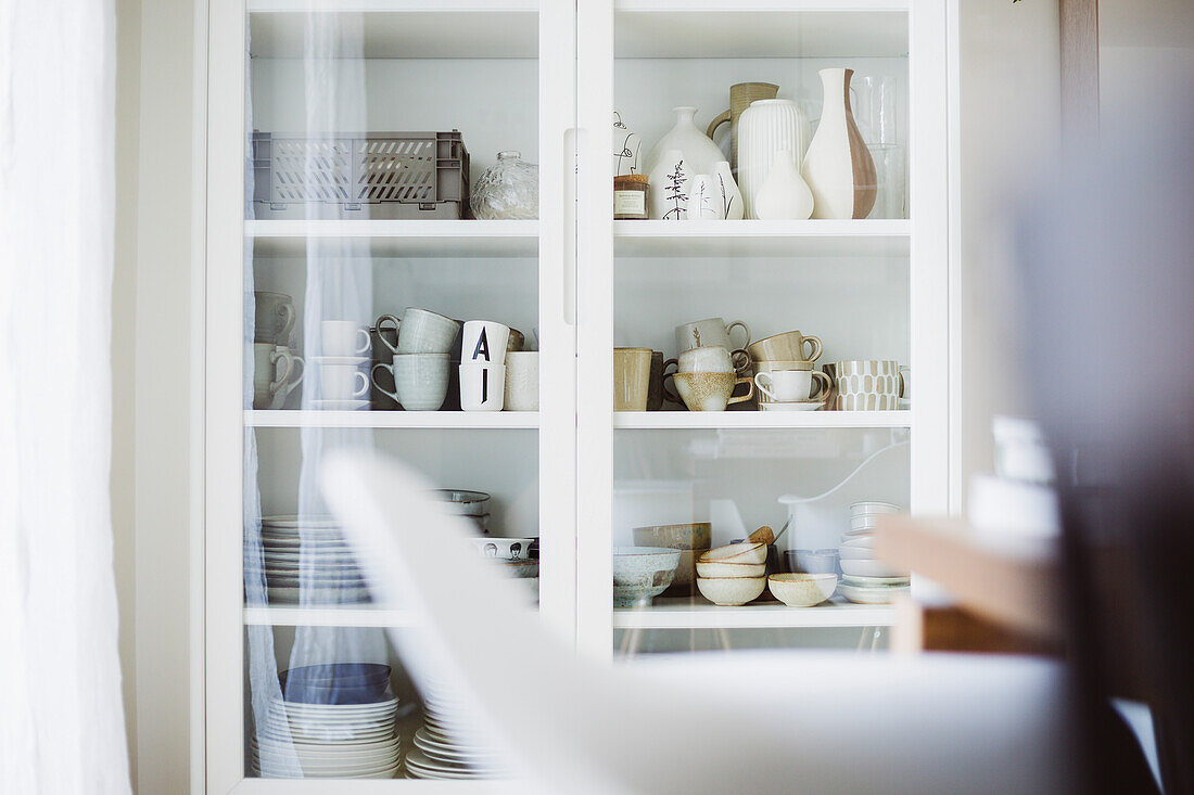 Display cabinet with cups, plates and vases