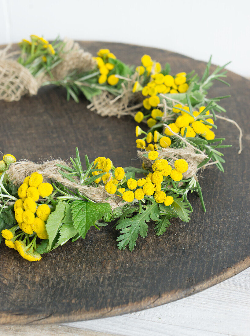 Wreath made of tansy (Tanacetum vulgare), hops (Humulus), blackberry leaves (Rubus) and sack ribbon
