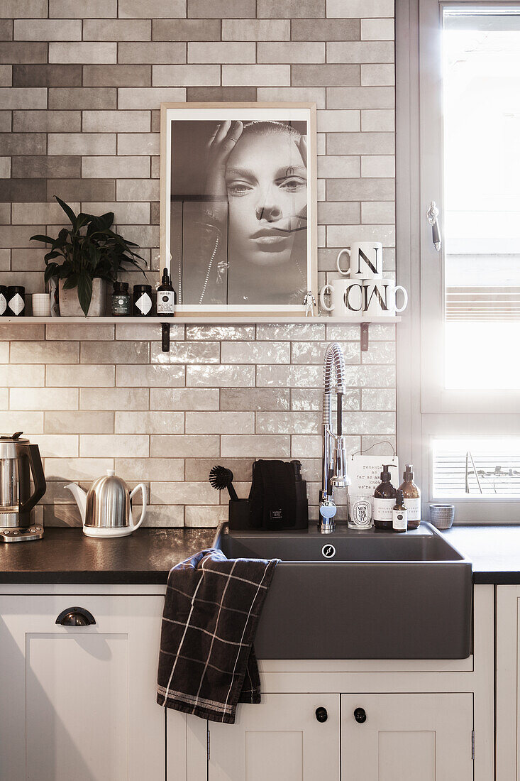 Kitchen with dark grey sink and metro tiles