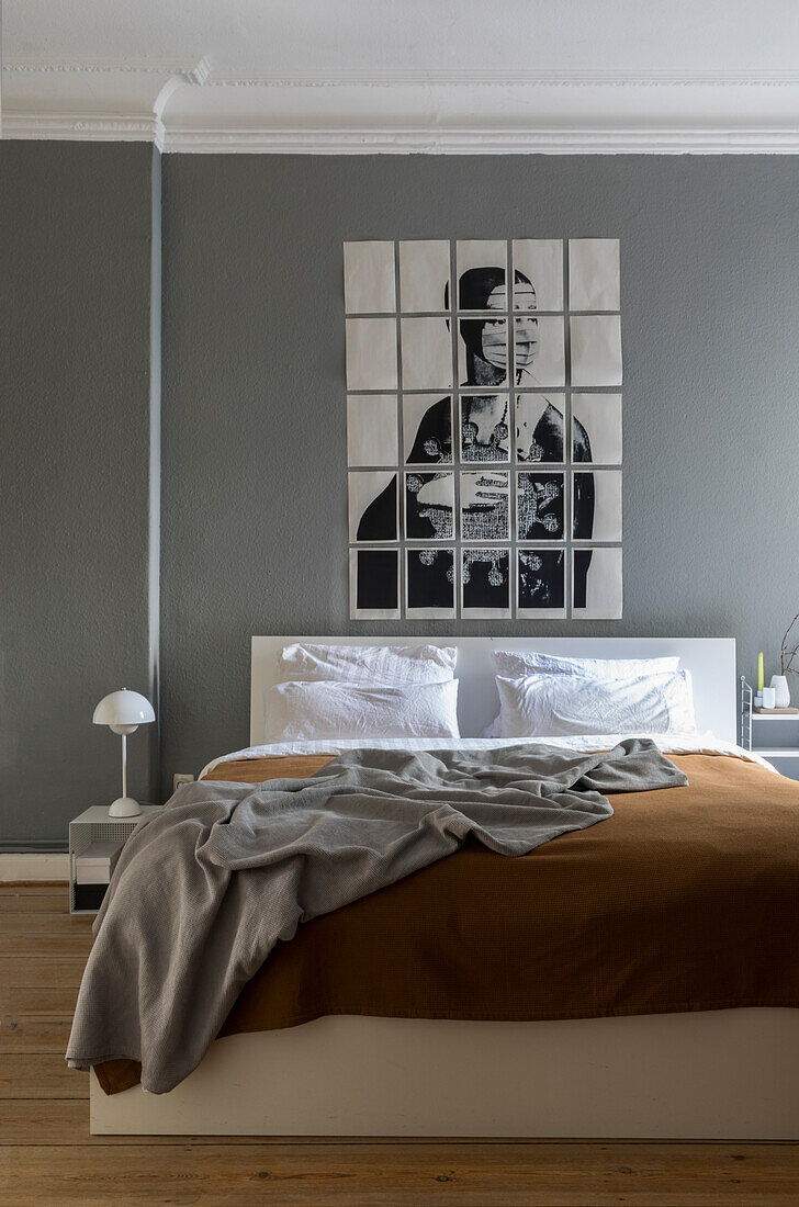 Artwork above bed in a bedroom with grey walls