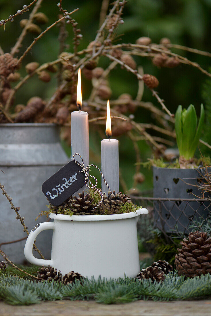 Winter decoration with candles on a plant table