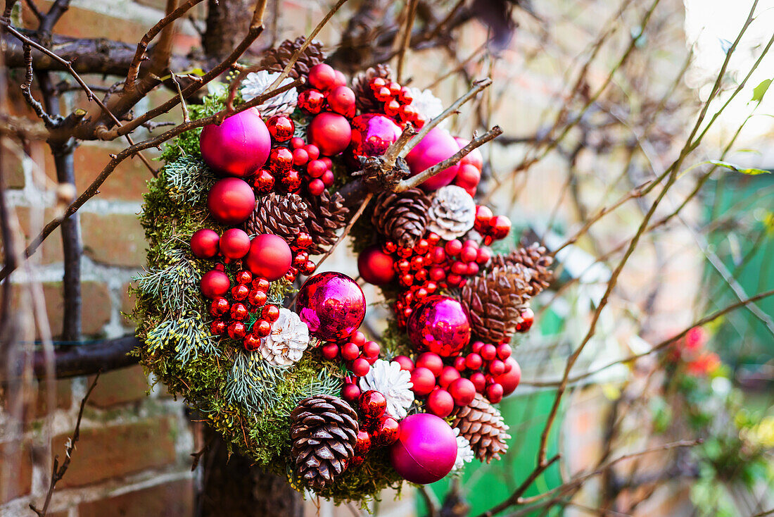 Wreath with Christmas ornaments hanging from branches