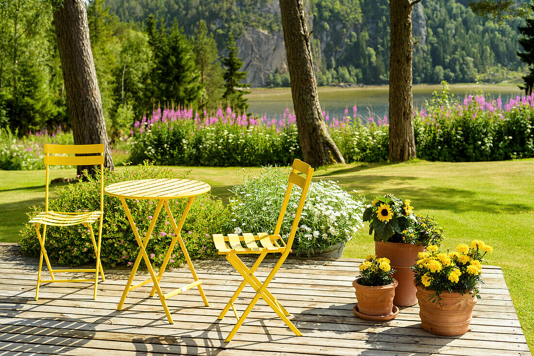 Summery yellow chairs and table on terrace