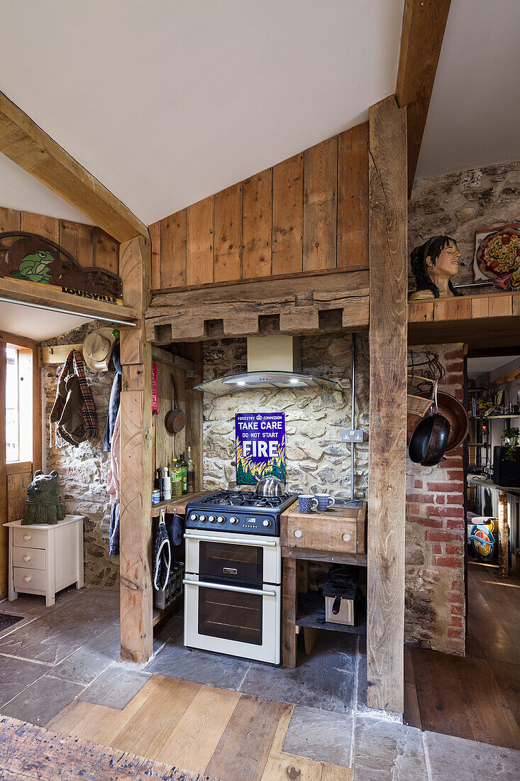 Rustic kitchen with wooden beams and natural stone wall