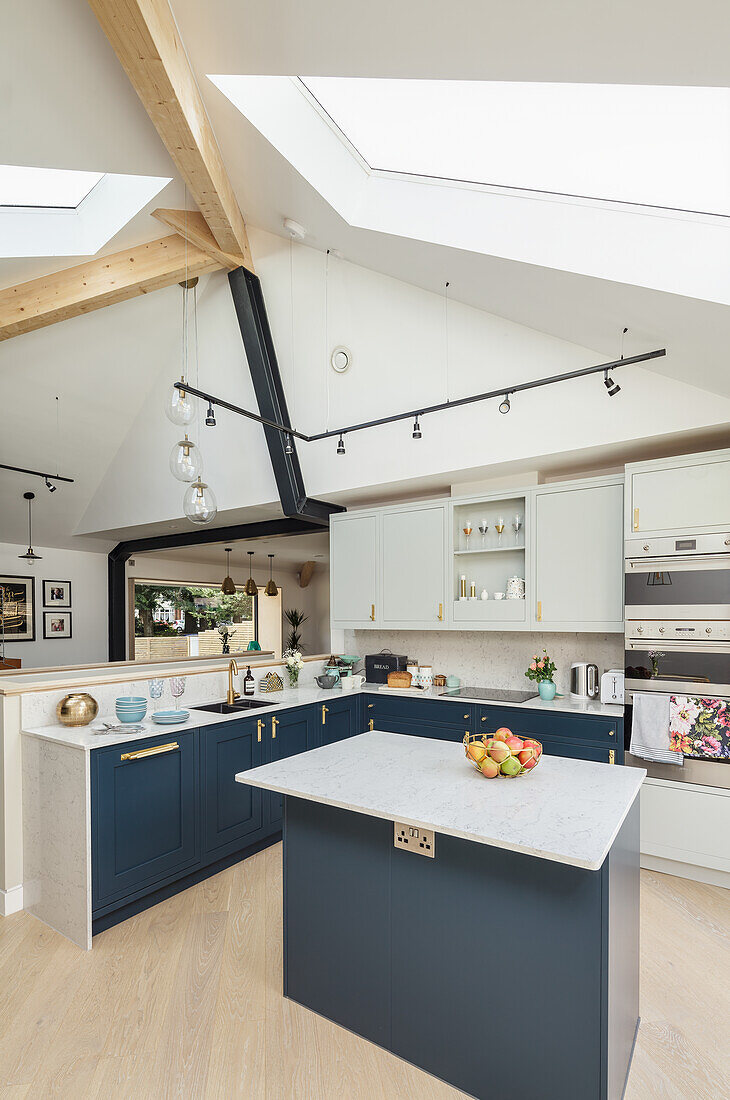 Kitchen island in bright, open kitchen with skylight