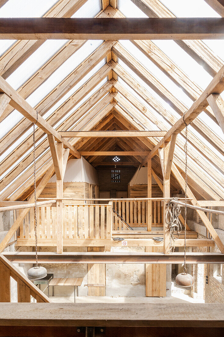 Light flooded attic with wooden beams