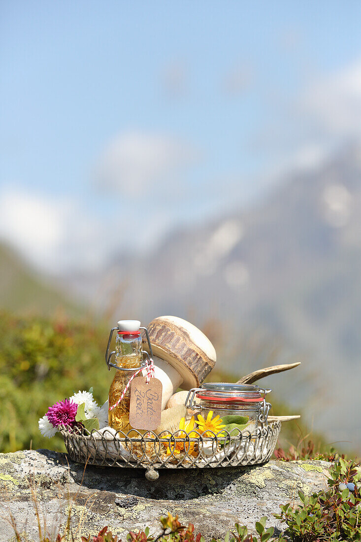 Alpine homemade cosmetics - tray with flowers and bath oils and salts