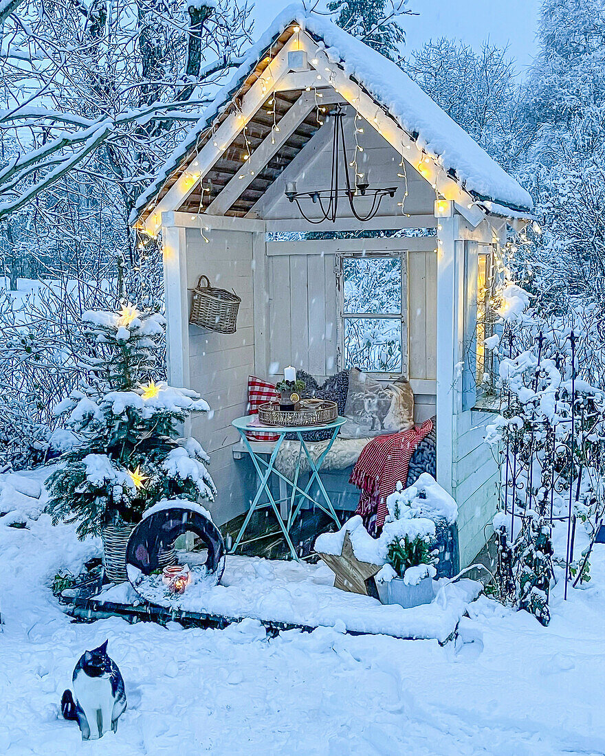 Arbour decorated for Christmas in snow-covered garden