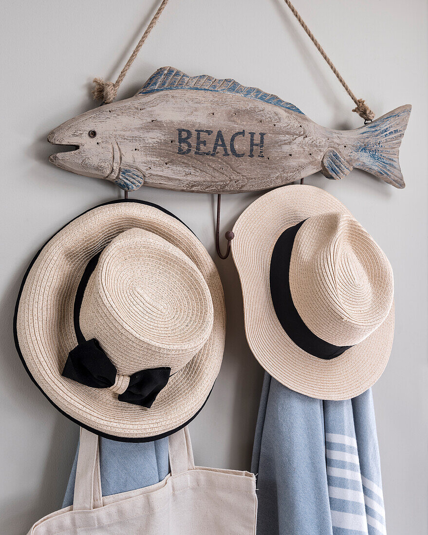 Driftwood fish as wall coat rack with sun hats and towels
