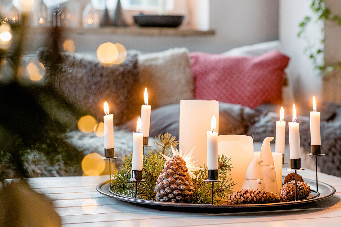 Christmas table decoration with candles and cones
