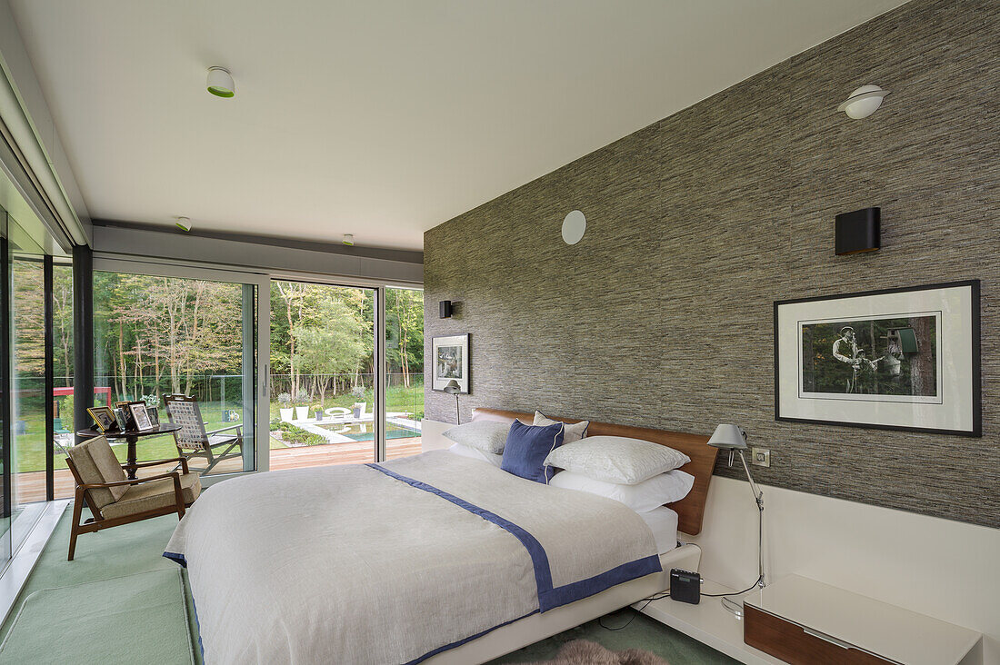 Modern bedroom with wrap-around window front