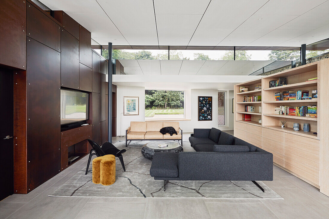 Open-plan living room with bespoke furniture and views of the garden.