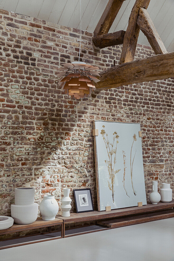 Shelf with decorative objects against brick wall