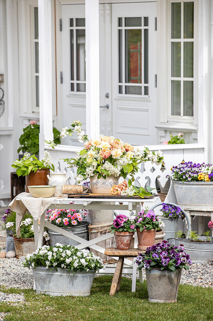 Flower arrangement in front of a white painted Scandinavian house