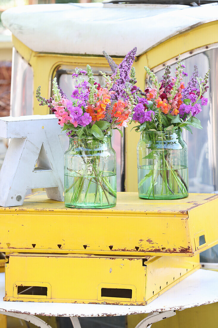 Bouquet of snapdragons in glasses in a discarded gondola