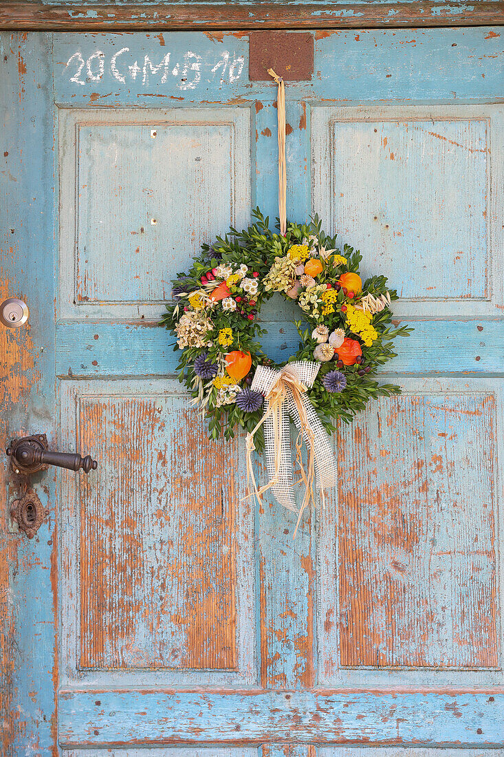 Late summer wreath on blue wooden door