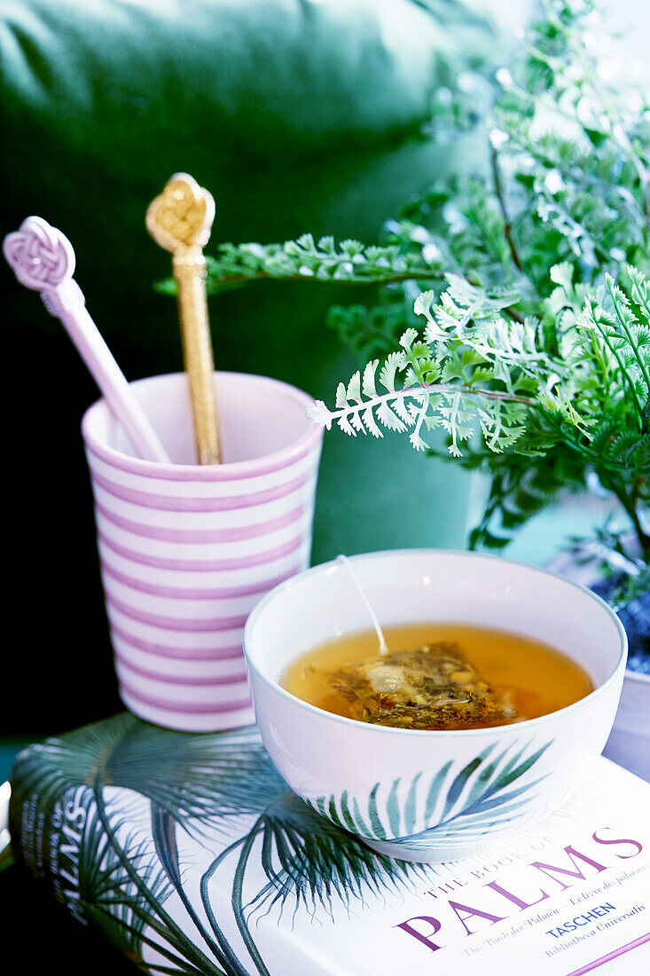 Bowl of tea and and stirrers in mug