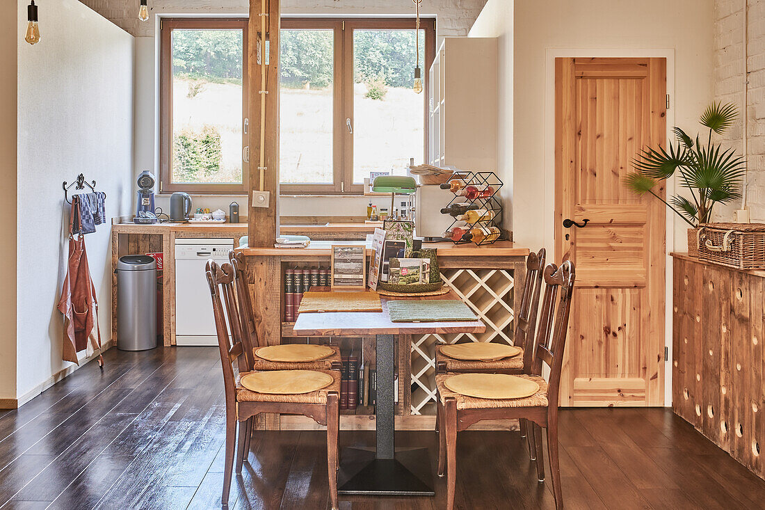 A table with wicker chairs in a country kitchen