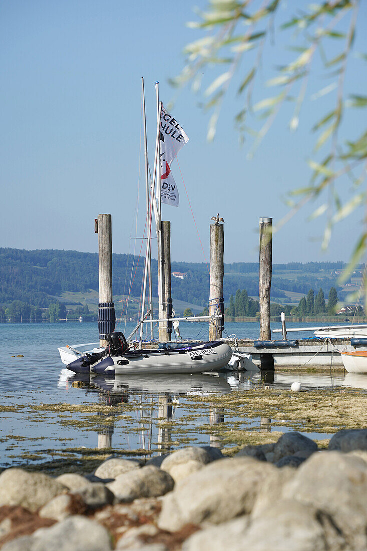 Dinghy, jetty and lake in summer