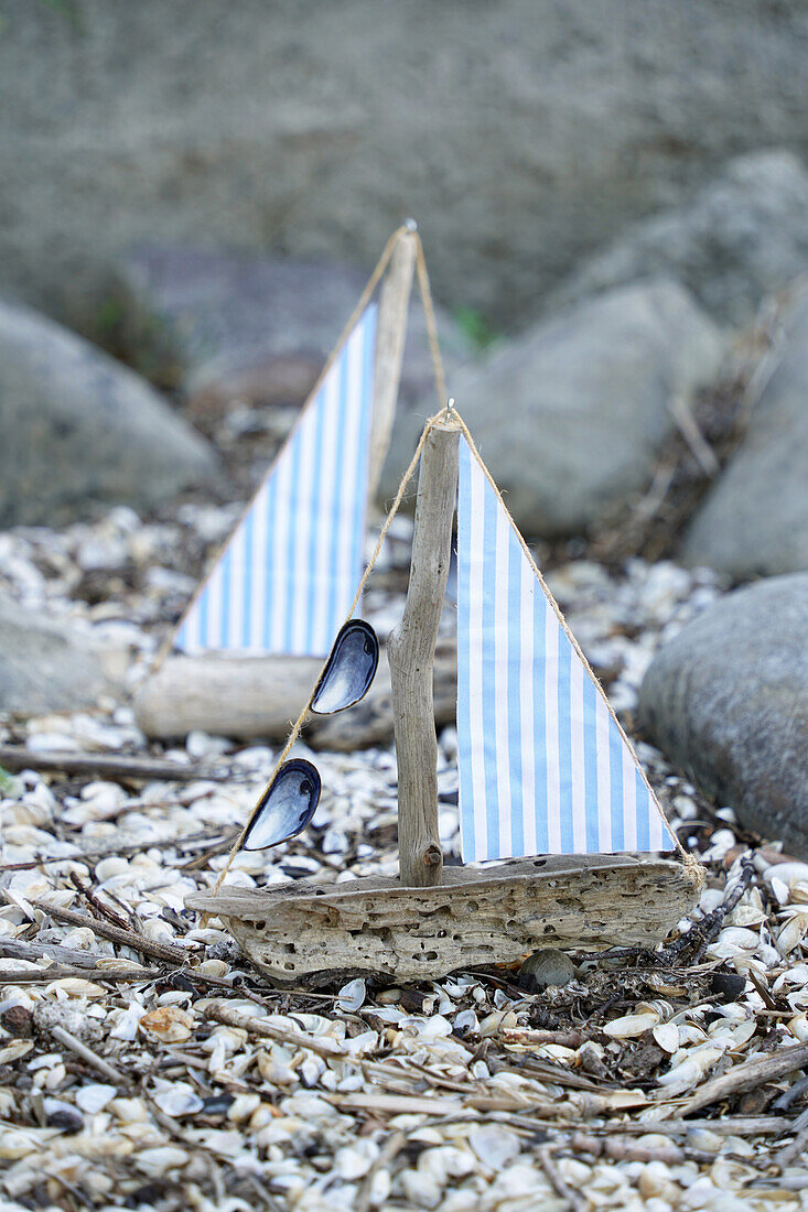 DIY sailboat made from driftwood, fabric and mussel shells