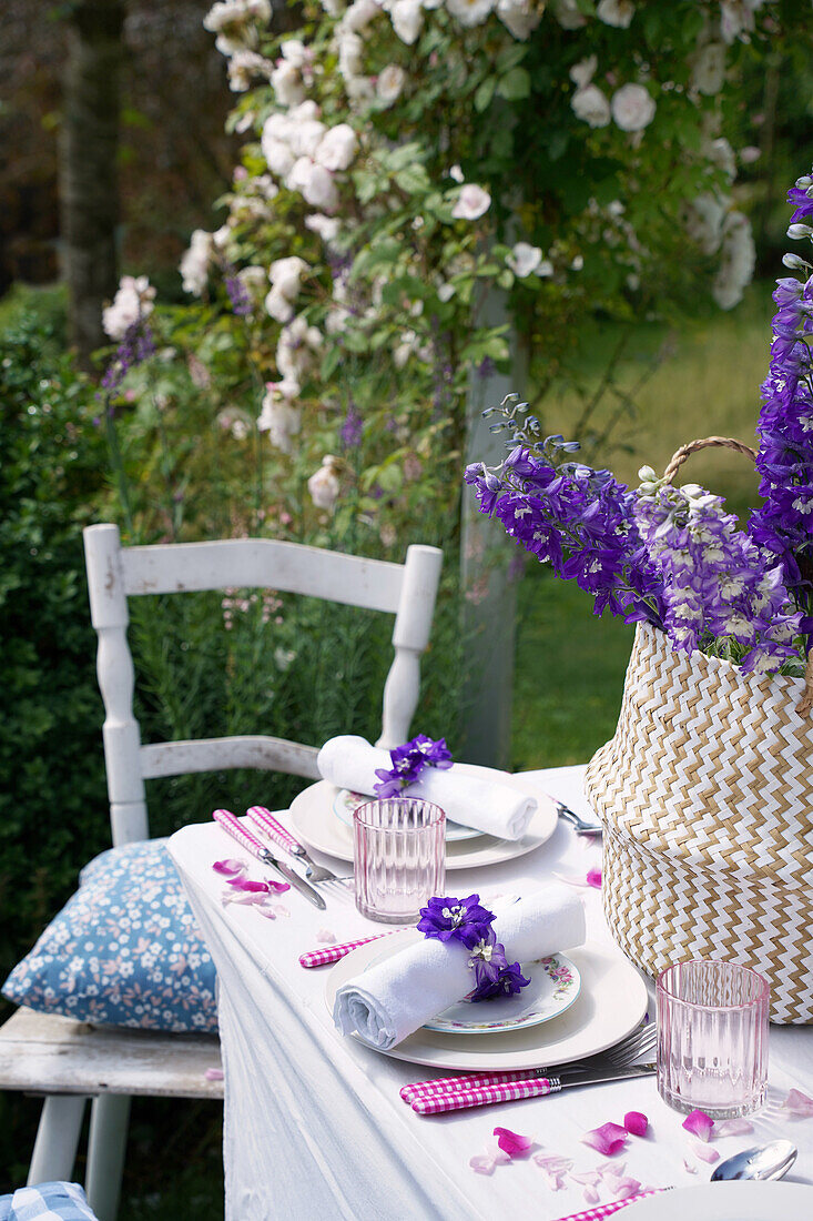 Outdoor table setting decorated with delphinium flowers