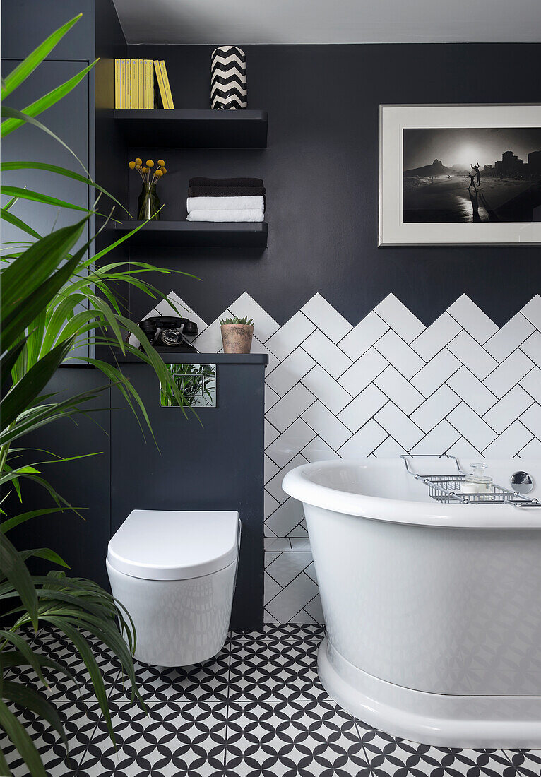 Black and white bathroom, wall tiles in herringbone pattern