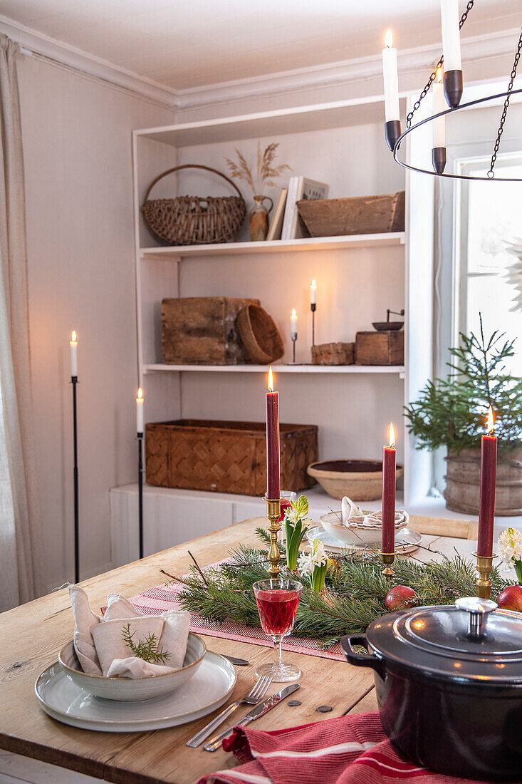 Dining table set with candles and Christmas decorations