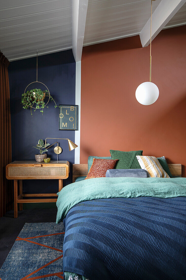 Bedroom with color contrast: blue, rust red, green