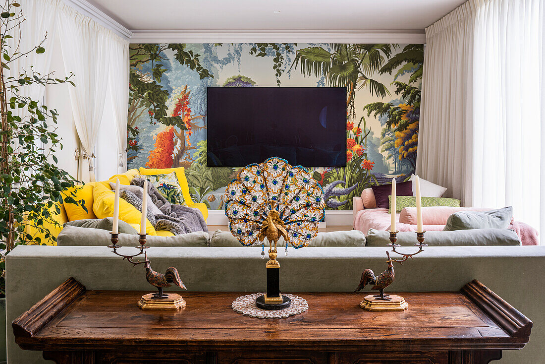 Colourful living room with hand-painted wallpaper and 1930s peacock lamp