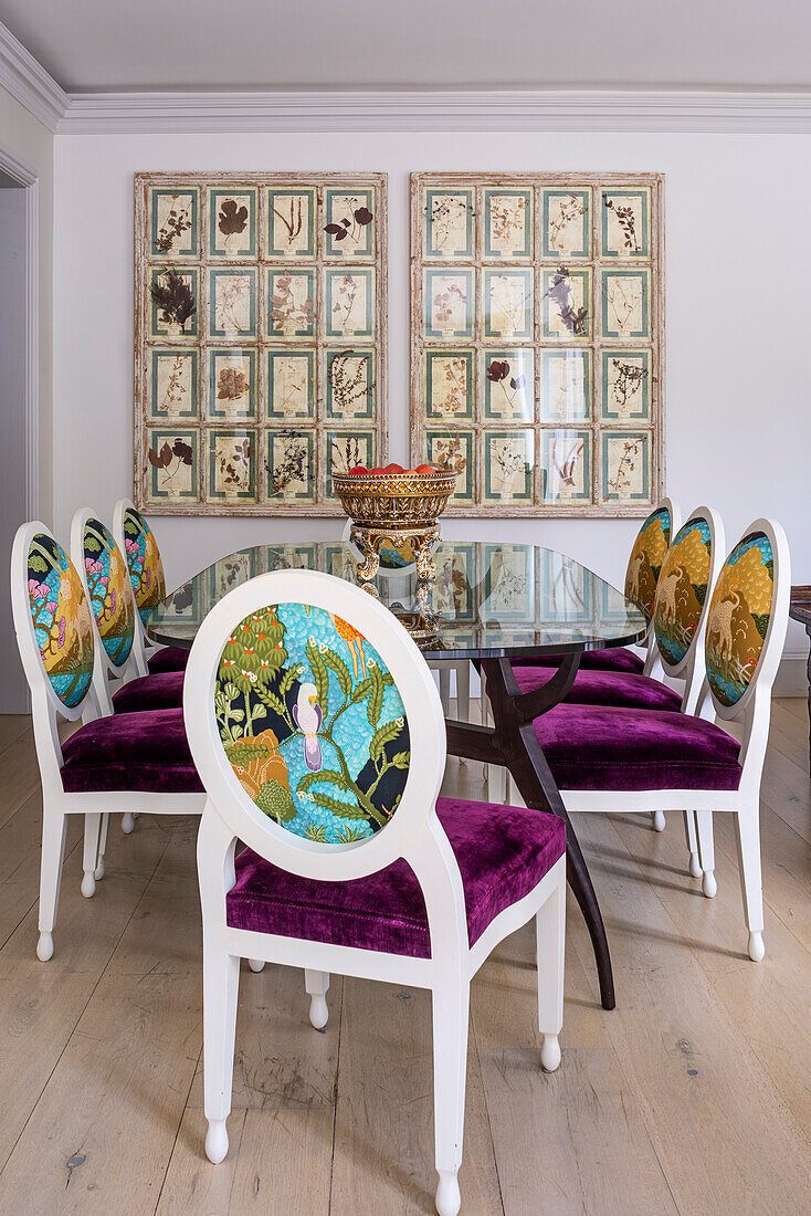 Dining room with upholstered chairs in 'Shangri-La' fabric and dried flower pictures