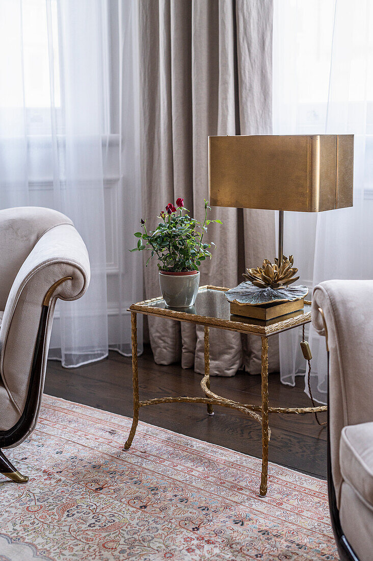 Classic living room with bronze table lamp and armchairs