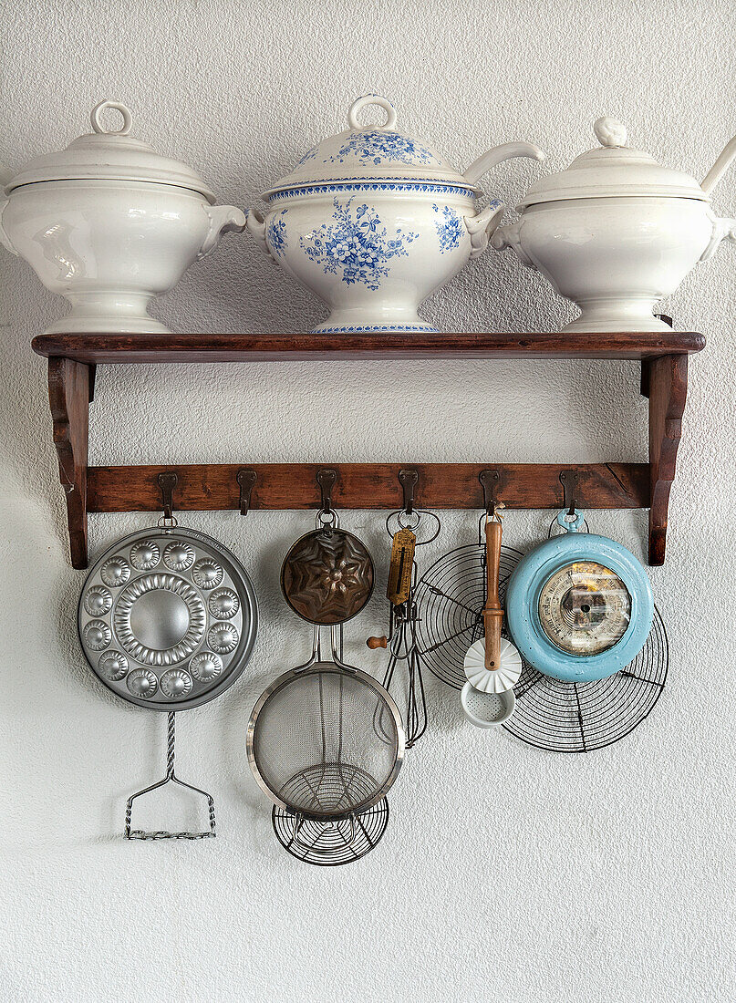 Vintage kitchen shelf with porcelain bowls and old baking tins