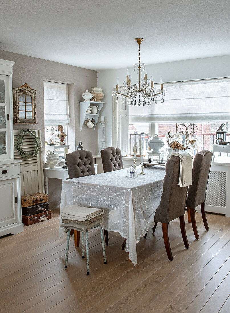 Vintage-style dining room with chandelier and white tablecloth