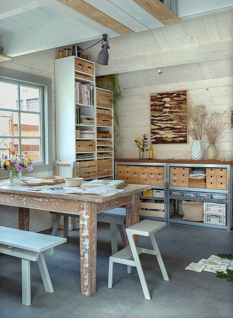 Scandinavian study with wooden table and shelves made from crates