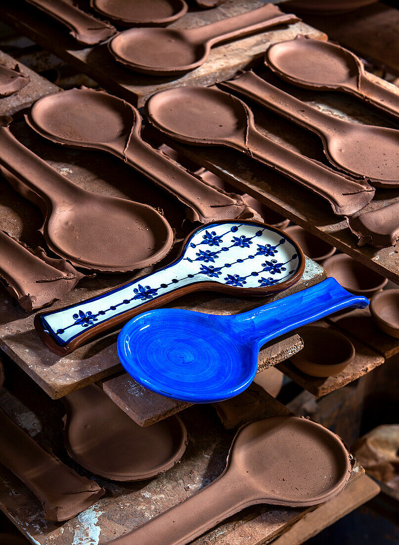 Traditionell glasierte Löffel aus Keramik in Blau und Weiß auf Tonrohlingen