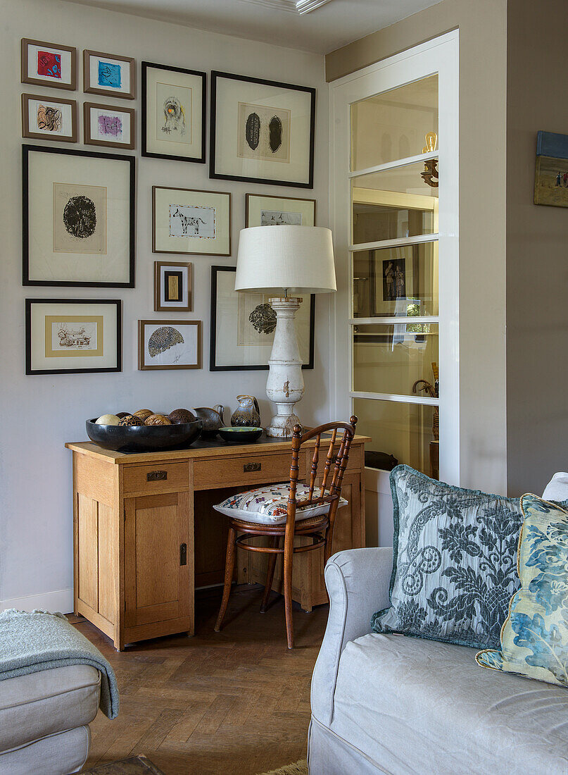 Eckschreibtisch aus Holz mit Bildergalerie an der Wand im Wohnzimmer