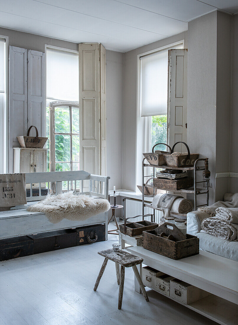 Bright country-style living room with white wooden furniture and rustic decorative items