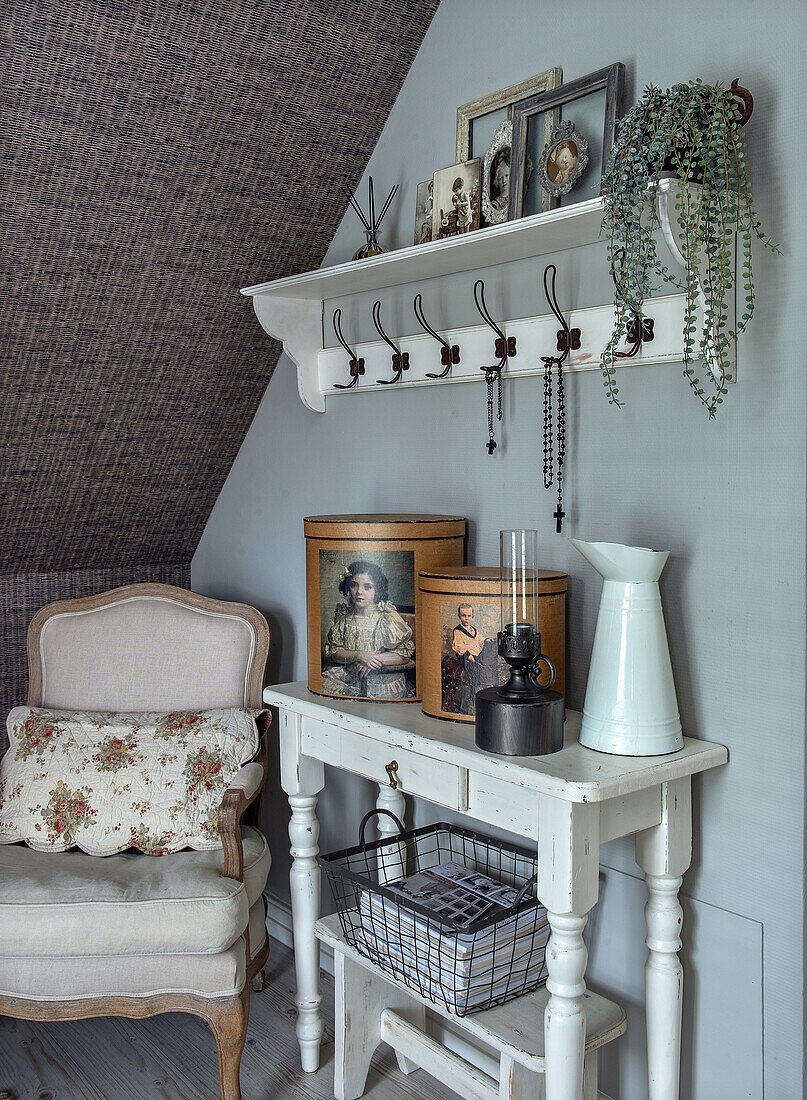 Vintage corner under a sloping roof with armchair, wardrobe and wall console