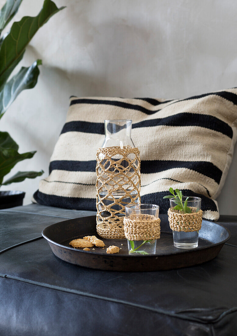 Drink set with macramé in the living room on a leather sofa