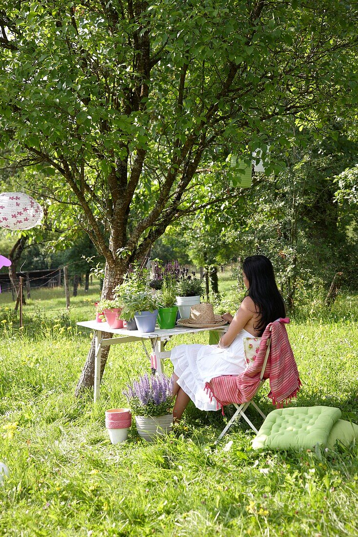 Woman sitting in orchard