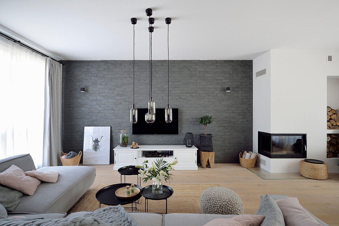 Modern living room with fireplace and hanging pendant lights