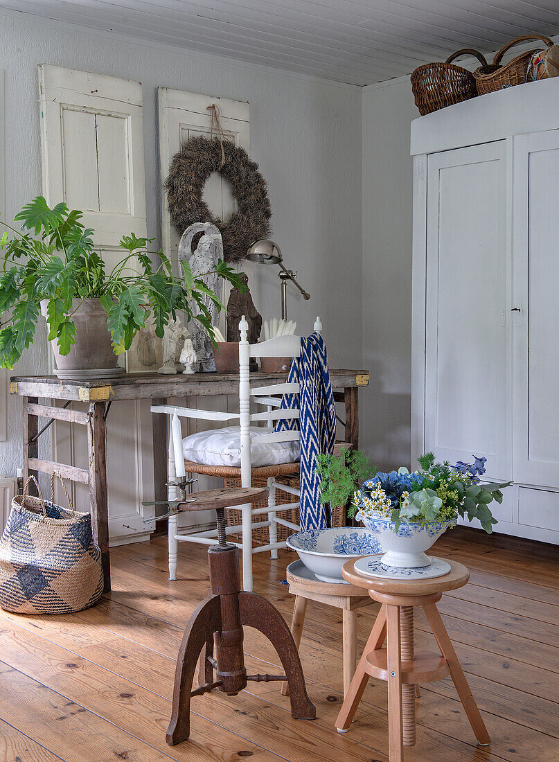 Rustic living room with houseplant, decorative objects and wooden floor