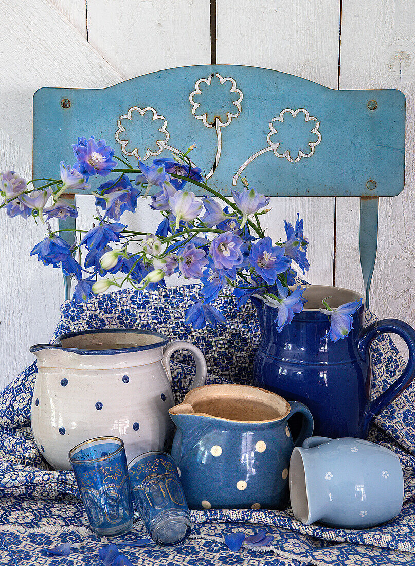 Blue chair with blue and white ceramics and blue flowers