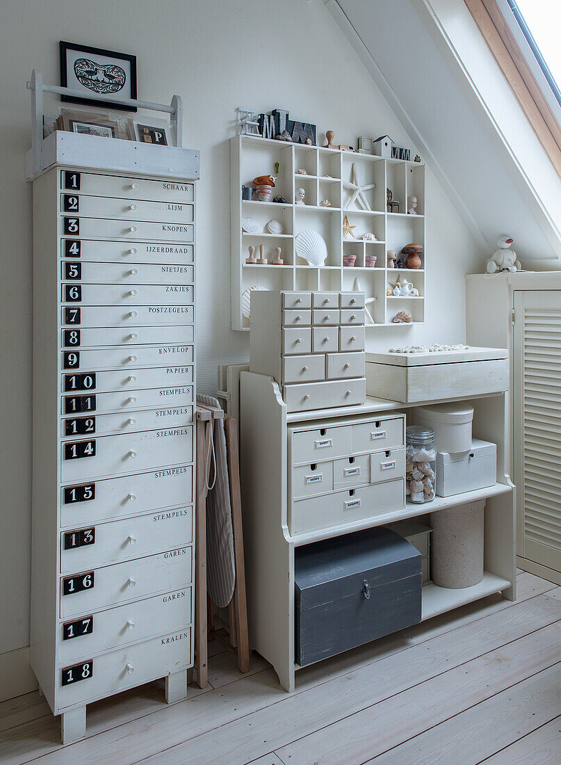 Organised storage solutions for craft materials in a bright attic room